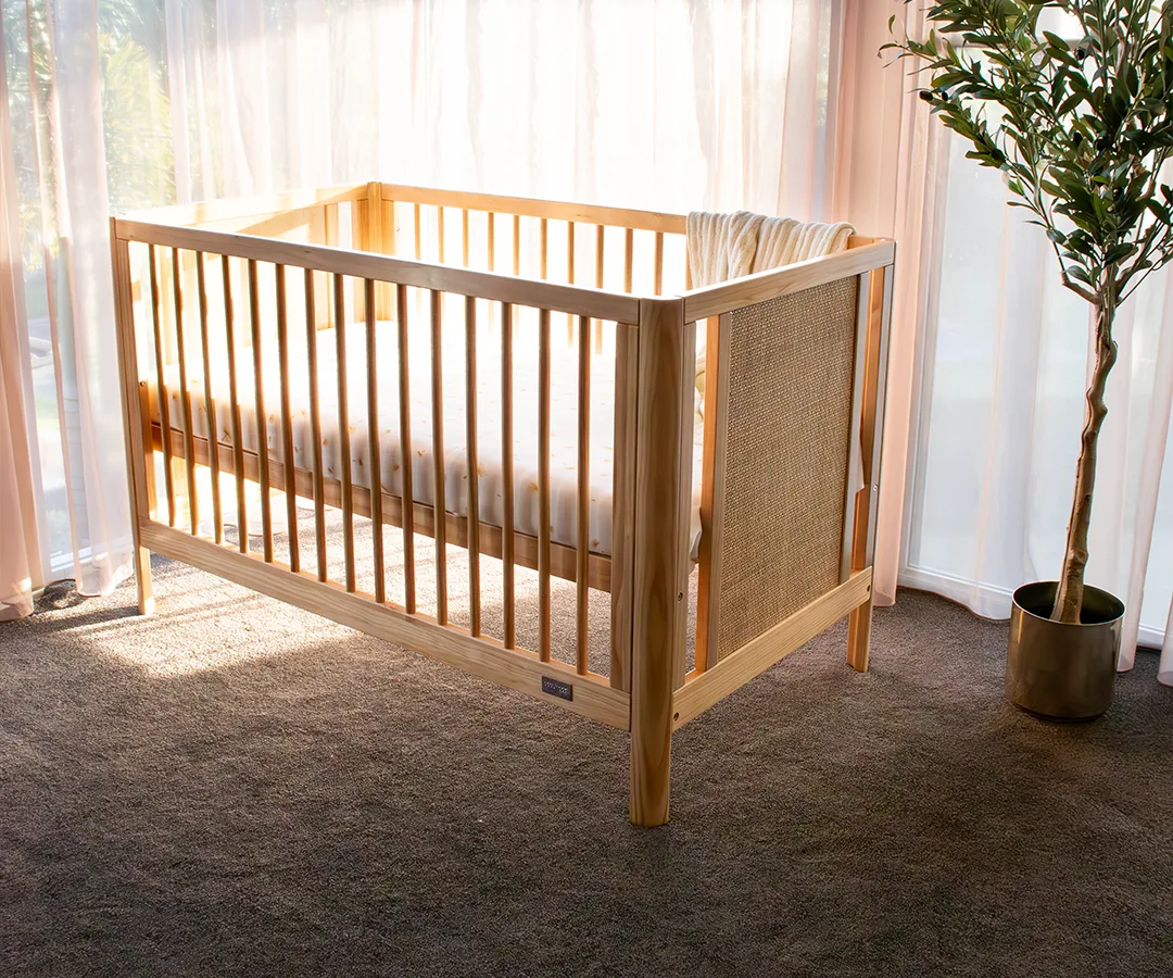 Babyhood Aliya Rattan Cot shown as a natural timber toddler bed