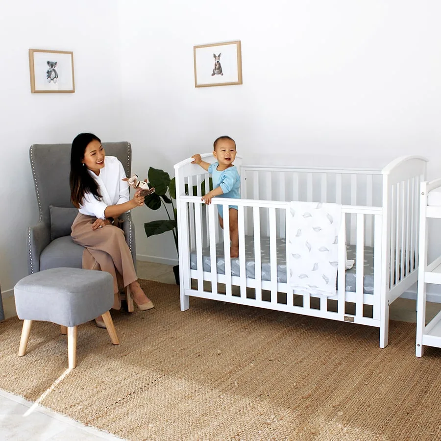 White Babyhood Classic Curve Cot in a nursery