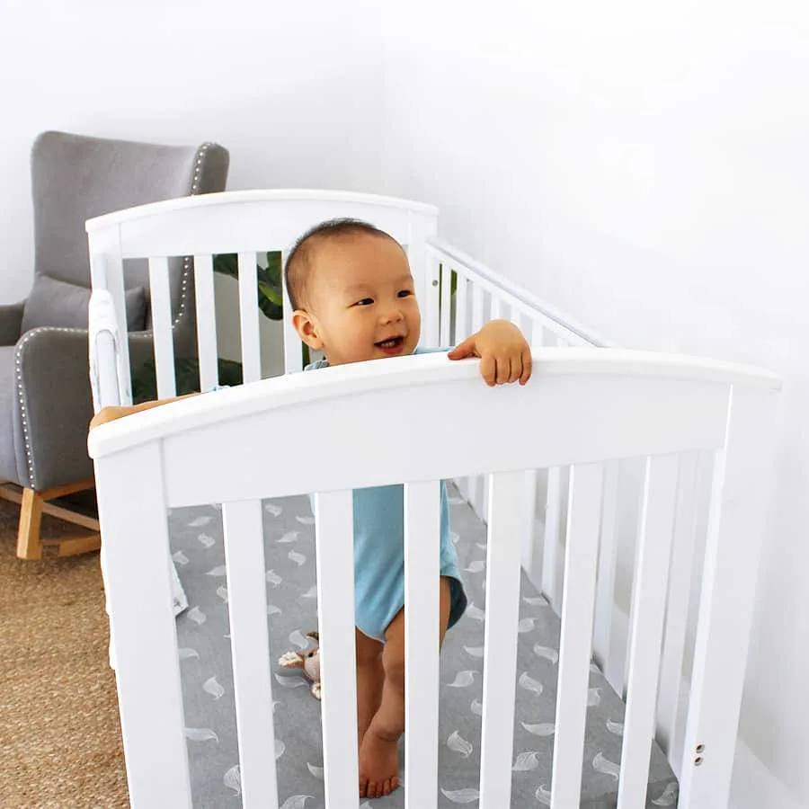 Classic Curve Cot shown in a natural timber finish