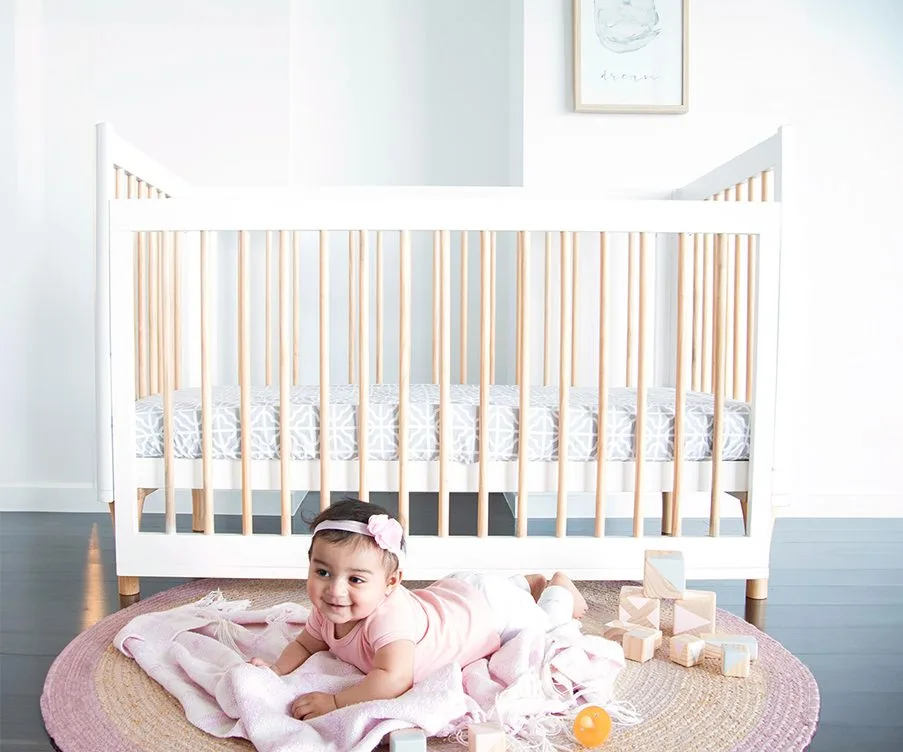 Natural and white Babyhood Riya Cot in a bright nursery