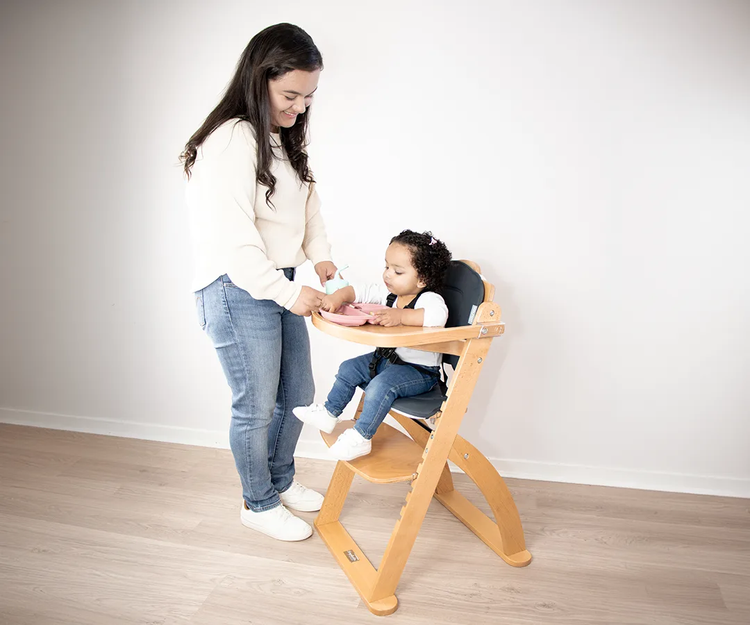 Kaylula Ava high chair shown at a family dining table