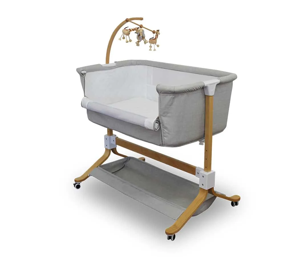 Grey Kaylula Co Sleeper Cradle with timber legs and storage basket