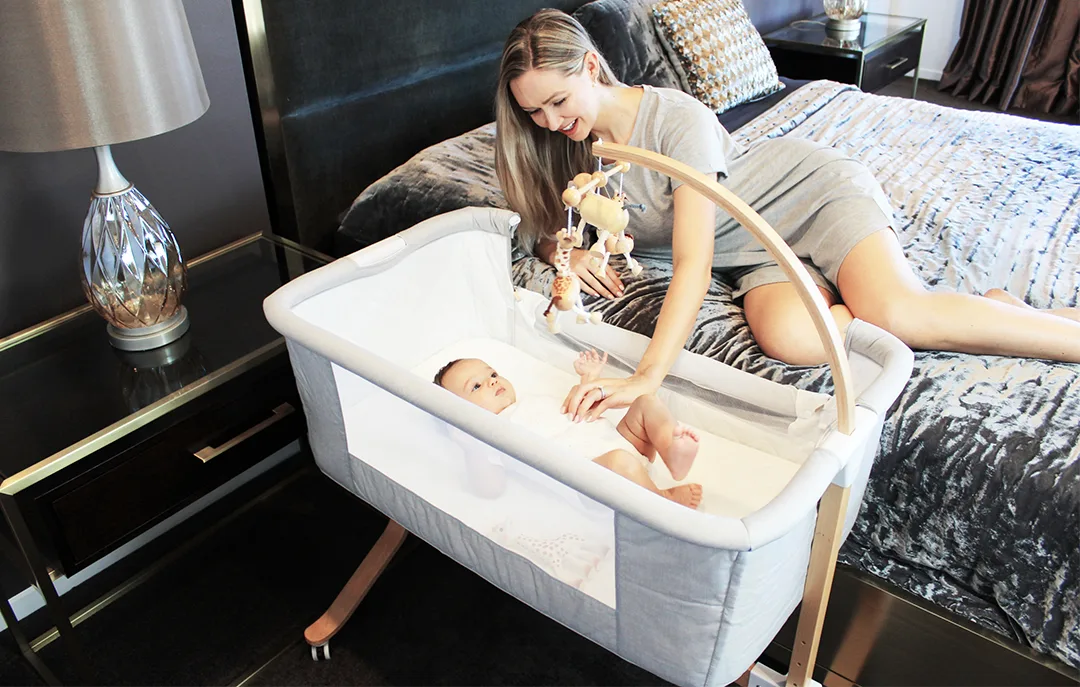 Kaylula Co Sleeper Cradle positioned beside an adult bed